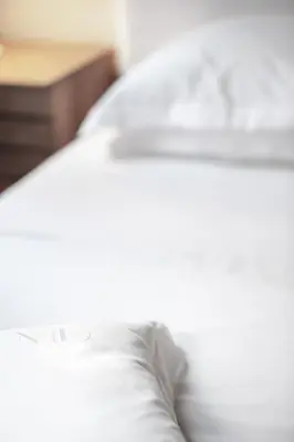 a close up of a bed with white pillows at Maison Dauphine in Aix-en-Provence