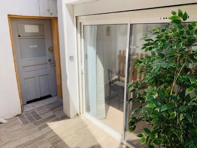 a sliding glass door with a plant next to it at Montclar Studio in Aix-en-Provence