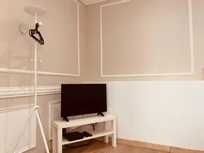a living room with a television on a table at Montclar Studio in Aix-en-Provence