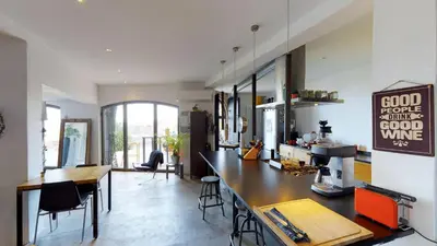 a kitchen with a long table and some chairs at Metafort in Méthamis