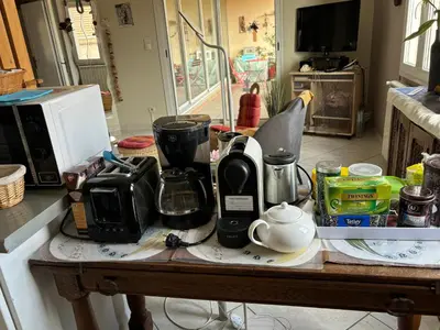 a kitchen counter with a coffee maker on a table at Appartement 