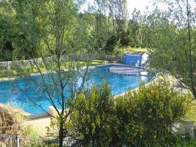 a large swimming pool with blue water in a yard at Moulin d'Antelon B&B in Crillon-le-Brave