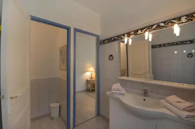 a bathroom with a tub and a sink and a mirror at Moulin d'Antelon B&B in Crillon-le-Brave