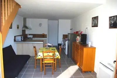 a kitchen and dining room with a table and chairs at Gite le Mas de l'Amandier in Saint-Saturnin-lès-Avignon