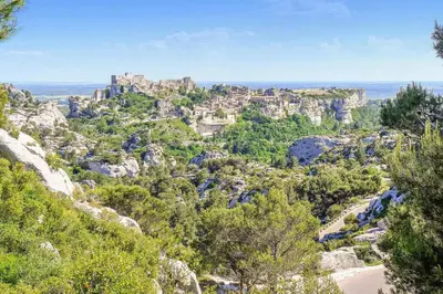 a view of a mountain with a castle on top at Villa envoûtante à Eyragues avec piscine in Eyragues
