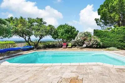 a swimming pool in a yard with a fence and trees at Villa envoûtante à Eyragues avec piscine in Eyragues