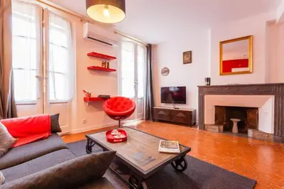a living room with a couch and a fireplace at L'Entrecasteaux in Aix-en-Provence