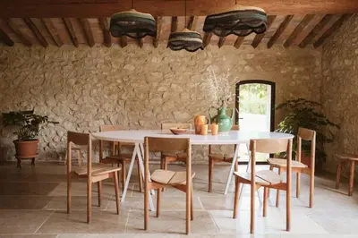 a pool with lounge chairs and an umbrella next to a pool at Le Galinier Lourmarin, a Beaumier Guesthouse in Lourmarin