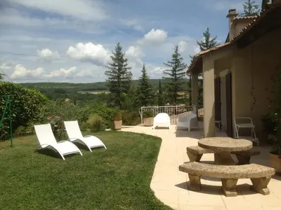 a group of chairs and benches in a yard at Villa élégante à Céreste avec piscine privée et jacuzzi in Céreste