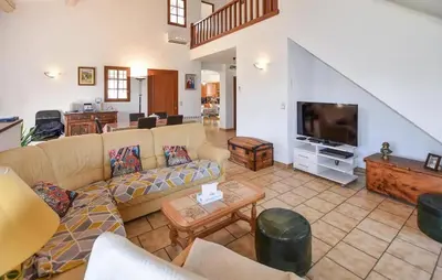a living room with a couch and a flat screen tv at Maison provençale avec cheminée à Loriol-du-Comtat, jardin privatif in Loriol-du-Comtat