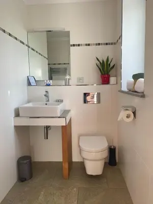 a bathroom with a sink and a toilet and a mirror at Domaine de l'Enclos in Gordes