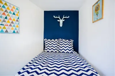 a bedroom with a bed with a blue head board at LEYDET in Aix-en-Provence