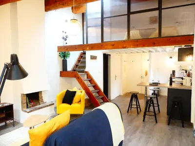 a living room and kitchen with a loft at Les Bernardines in Aix-en-Provence