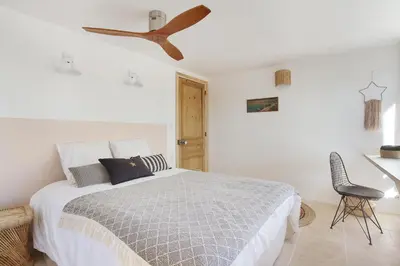 a bedroom with a bed with a ceiling fan at Domaine Les Petites Vaines in Goult