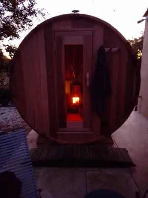 a wooden circular house with a fire in it at Le Fournil en Provence in Caseneuve