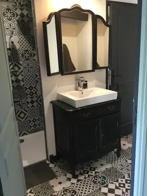 a bathroom with a sink and a mirror at authentic provencal mas with pool, in the countryside of the village of sénas, close to the luberon and the alpilles, sleeps 8. in Sénas