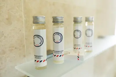 a group of four bottles sitting on a shelf at Hôtel Mas Valentine in Saint-Rémy-de-Provence