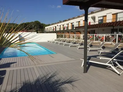 a row of lounge chairs sitting on a patio at Appart Hôtel Cézanne in Aix-en-Provence