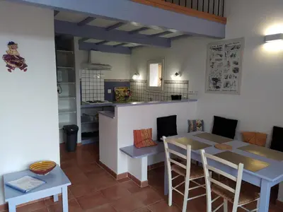 a kitchen and dining room with a table and chairs at AU PIED DU VENTOUX in Flassan