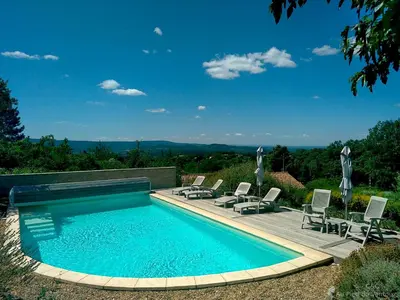 a swimming pool with lounge chairs and a swimming pool at AU PIED DU VENTOUX in Flassan