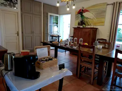 a dining room with a table and chairs and a table sidx sidx at AU PIED DU VENTOUX in Flassan