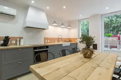 a kitchen with a wooden table with a wooden counter top at Petite Maison du Ventoux in Mormoiron