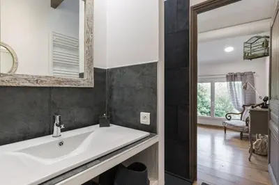 a bathroom with a white sink and a mirror at Petite Maison du Ventoux in Mormoiron