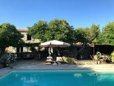 a pool with an umbrella and two chairs and a table with an umbrella at Splendid Villa in Viens with Swimming Pool in Viens