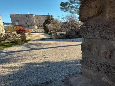 a stone wall in front of a building at Splendid Villa in Viens with Swimming Pool in Viens