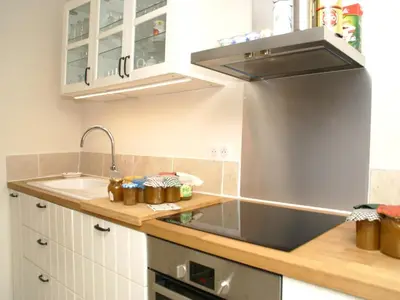 a kitchen with a sink and a stove at Splendid Villa in Viens with Swimming Pool in Viens