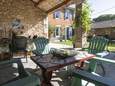 a wooden table and chairs on a patio at Holiday Home Bastide du 19ième by Interhome in Oppède