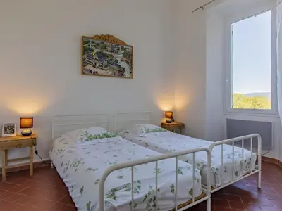 a bedroom with two beds and two windows at Holiday Home Bastide du 19ième by Interhome in Oppède