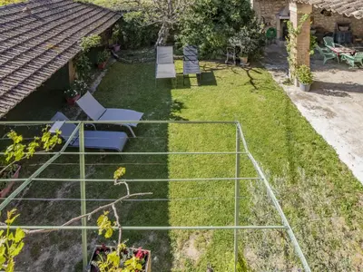 a garden with a net in the grass at Holiday Home Bastide du 19ième by Interhome in Oppède