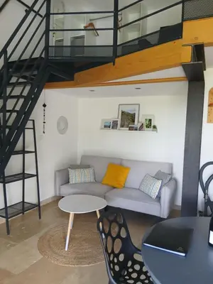 a living room with a couch and a table at les cerisiers de stella in Blauvac