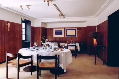 a dining room with a white table and chairs at Hotel Crillon le Brave in Crillon-le-Brave