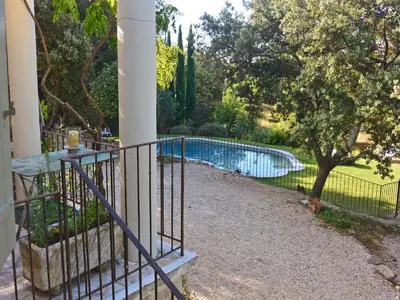 a fence around a swimming pool in a yard at Villa in Crillon-le-Brave near Mont Ventoux in Crillon-le-Brave