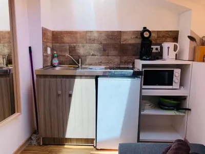 a small kitchen with a sink and a microwave at COURONNE STUDIO in Aix-en-Provence