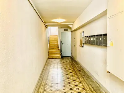 an empty hallway with a tile floor and stairs at COURONNE STUDIO in Aix-en-Provence