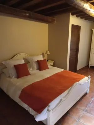 a bedroom with a large bed in a room at Le Vieux Moulin de Jouques in Jouques