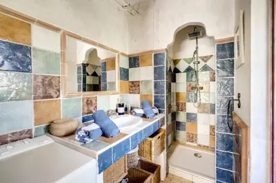 a bathroom with a tub and a sink at Le Mas des Anges in Cheval-Blanc