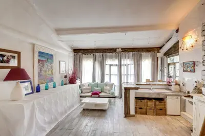 a living room with a couch and a table at Le Mas des Anges in Cheval-Blanc