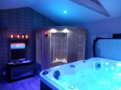a large bathroom with a tub and a television at Suite luxe avec sauna et jacuzzi privée in Lambesc