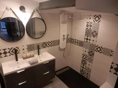 a bathroom with a sink and a mirror and a shower at Suite luxe avec sauna et jacuzzi privée in Lambesc