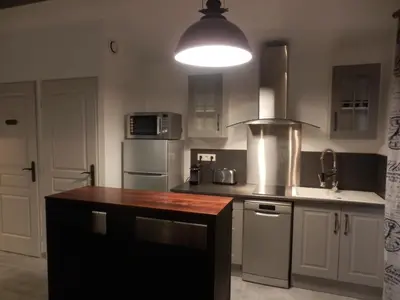a kitchen with a counter top and a light at Suite luxe avec sauna et jacuzzi privée in Lambesc