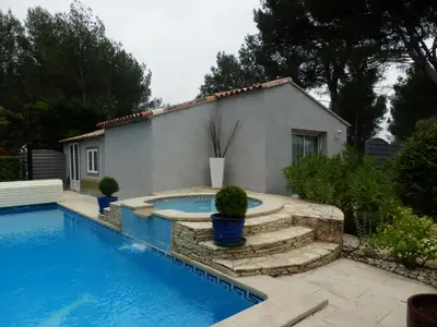a swimming pool in front of a house at Suite luxe avec sauna et jacuzzi privée in Lambesc