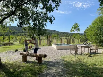 a man and a child playing on a bench at Le Domaine Saint Jean in Saint-Saturnin-les-Apt