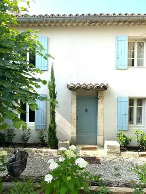 a white house with a blue door at Le Domaine Saint Jean in Saint-Saturnin-les-Apt