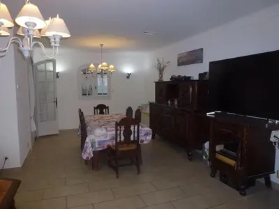 a dining room with a table and a piano at Chambre d'hôtes La Pinede in Lambesc