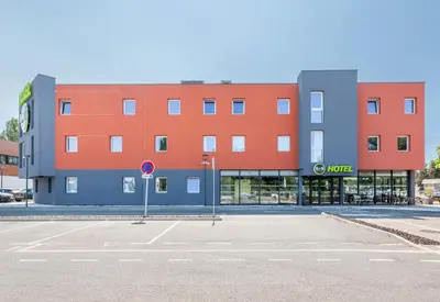 an empty parking lot in front of a building at B&B HOTEL Aix en Provence Venelles in Venelles