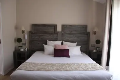 a bedroom with a large white bed with two pillows at Le Concorde in Aix-en-Provence